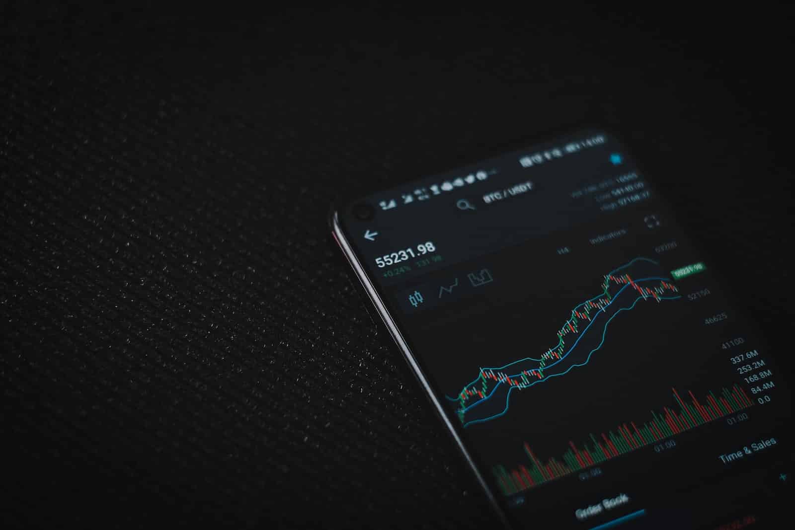 black android smartphone on black textile