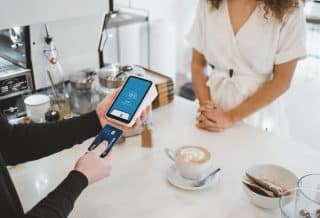 woman standing and holding smartphones