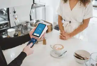 woman standing and holding smartphones