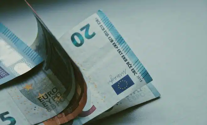 5 euro bill on white table